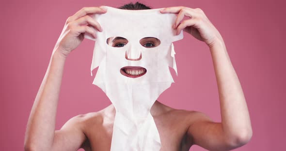 Smiling Girl Holding Facial Mask