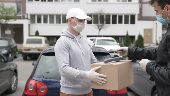 Parcel delivery during a pandemic. Payment via POS-wireless terminal with a card or smartphone