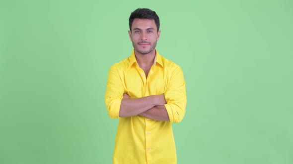 Happy Young Hispanic Businessman Smiling with Arms Crossed