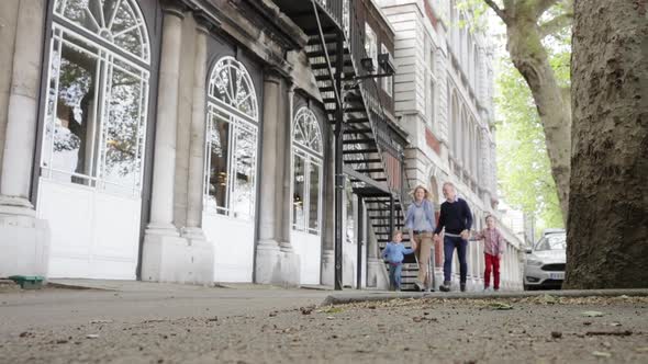 Happy family walking through the streets of London