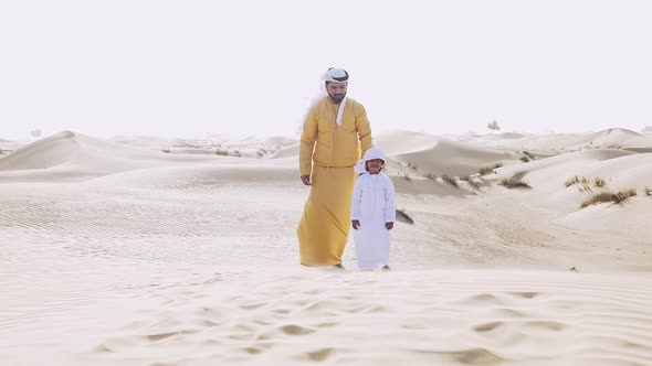 Father and son making a safari in the desert