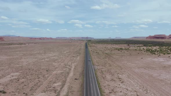 Car Traveling on Navajo Reservation Desert Road in Arizona - Aerial