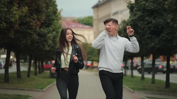 A Man and a Woman are Walking Around the City