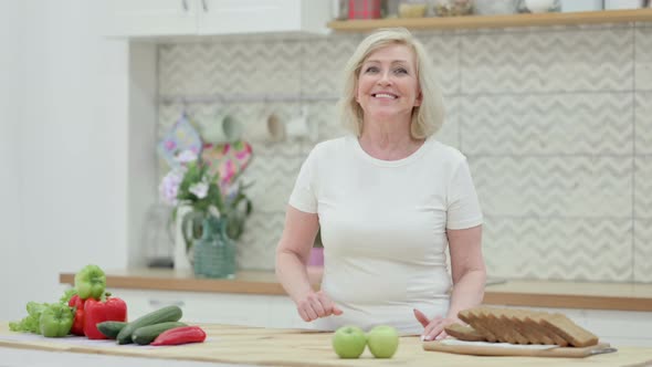 Senior Old Woman Shaking Head As Yes Sign While in Kitchen