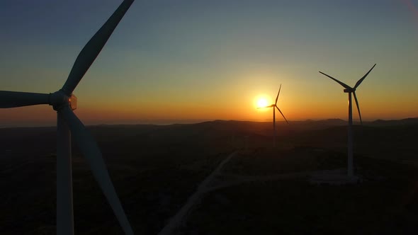 Close up of rotating windmill blades at sunset