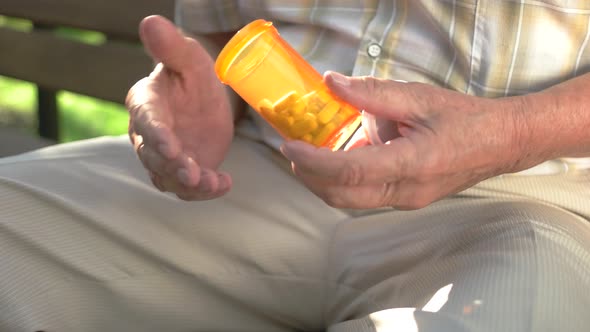Elderly Hand Holds Pills