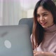 woman sit on the sofa in house and using laptop computer with type on a keyboard. - VideoHive Item for Sale