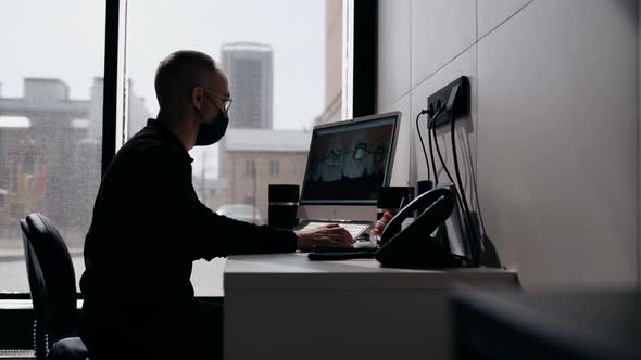 Doctor Orthodontist Looks at the Computer Monitor Studying the Picture of the Patient's Teeth