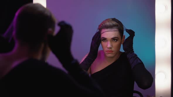 Beautiful Drag Queen Putting on Wig Cap Looking in Mirror, Cabaret Celebrity