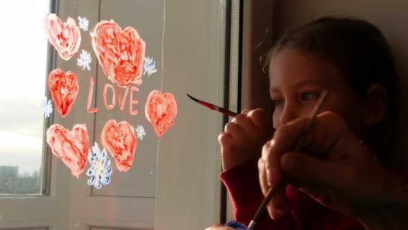 Child with father painting Valentine's day Love sign family art home playing indoors family leisure