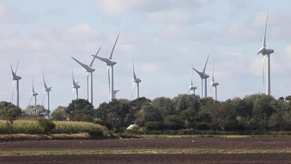 Wind farm seen across ploughed farmland. East Fresia, Lower Saxony. Germany. October 2020