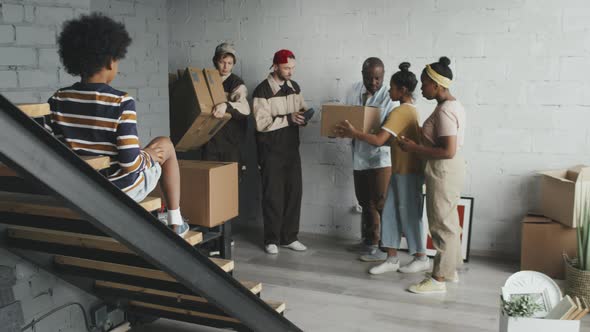 Slowmo of African-American Family Receiving Boxes from Movers