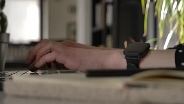 Video as woman types some text on laptop keyboard