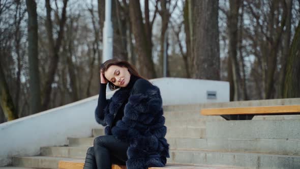 Luxury girl sitting on bench