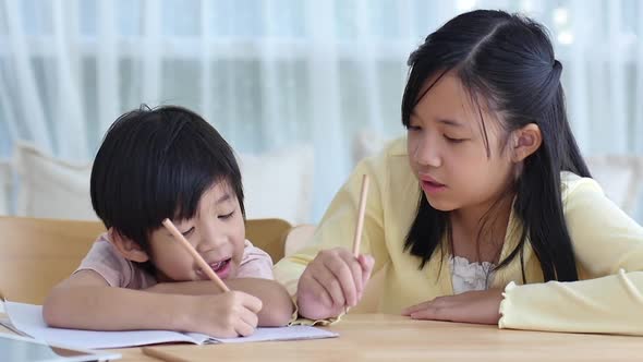 Asian Children Doing Homework Together