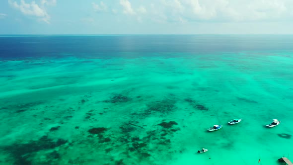 Aerial top view landscape of idyllic coast beach break by blue lagoon with white sandy background of