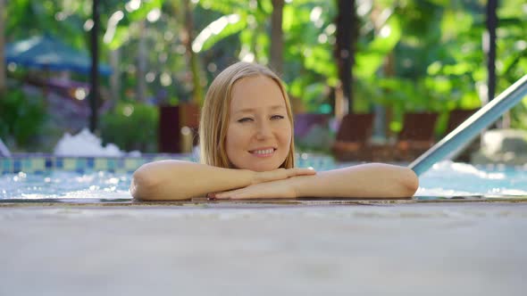 A Young Woman Relaxes and Has a Great Time in a Hot Springs Resort with Hot Water Swimming Pools