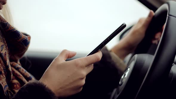 Texting And Driving Car On Smartphone.Checking Email Chats And Reading News.Female Writing Message