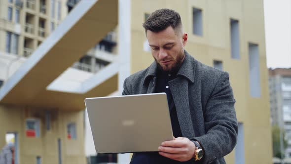 Portrait of a handsome man with a laptop.