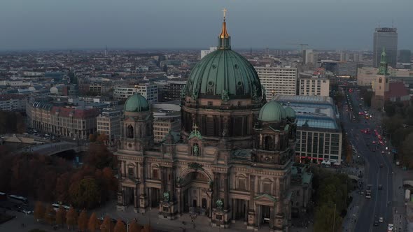 AERIAL: Circling Berlin Cathedral Beautiful Old Structure in Vibrant Fall Colors with Golden Cross