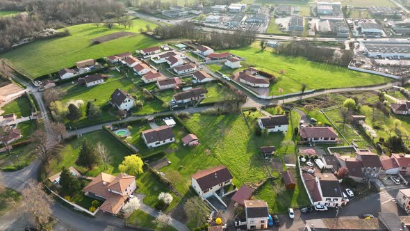 Aerial View of Suburban Landscape with Private Homes Between Green Fields in Quiet French