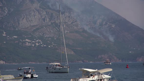 Sailboats Sail in the Sea in the Smoke From Forest Fires