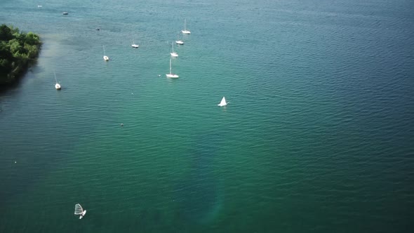 Fly Over Sailboats Anchored in a Bay on a Lake