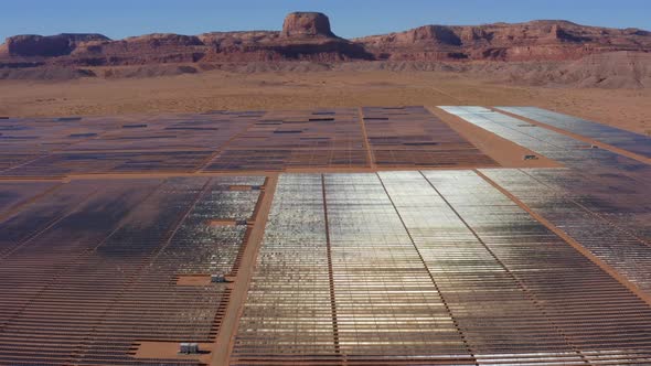 Aerial view moving over a large Solar Plant in the middle of the desert, Kayenta Arizona