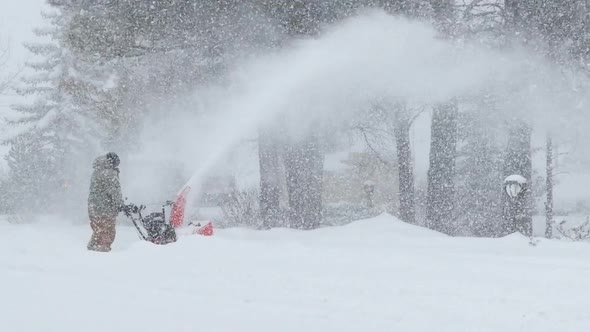 Man Using Snowblower in a Blizzard