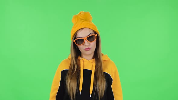 Portrait Frustrated Girl in Yellow Hat Is Taking Off Sunglasses and Saying Wow with Shocked Face