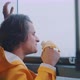 Young man looking out of foggy window while smiling and eating a banana - VideoHive Item for Sale