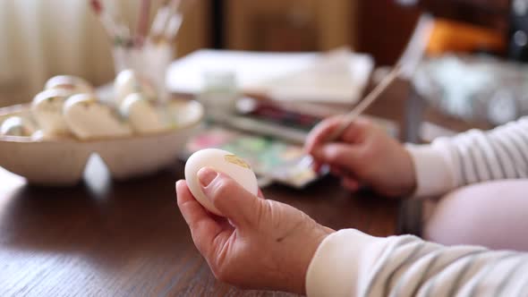 Woman Painting a Water Colors on Fantasy Chicken Eggs for Easter Egg Festival