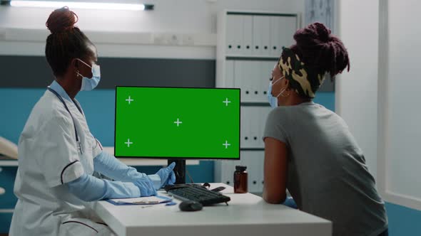 African American Doctor and Patient Looking at Green Screen