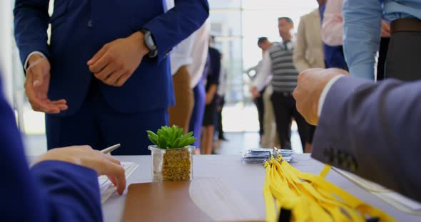 Business people checking in at the conference registration table 4k