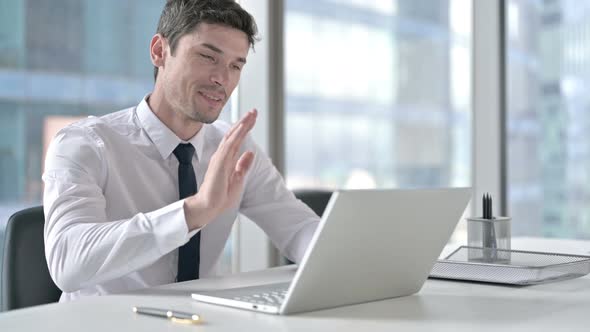 Young Businessman Doing Video Chat at Work