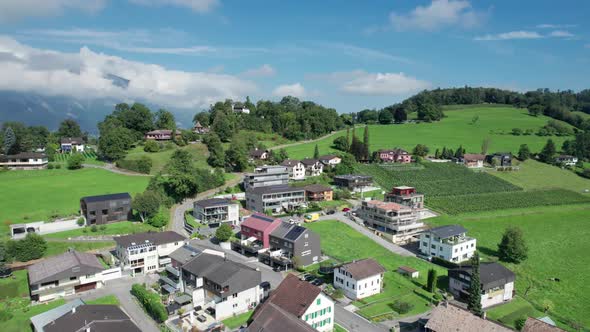 Aerial View of Liechtenstein with Houses on Green Fields in Alps Mountain Valley