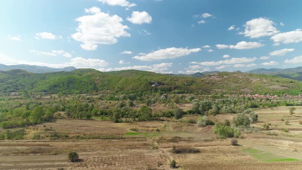 Uninhabited Area Flight Over Drone Shot. Blue sky and clouds.