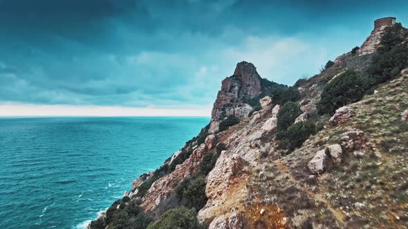 Top View of Wild Cliffs with Blue Sea on Sky Background