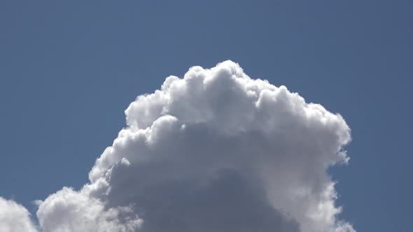 White Fluffy Cloud Exploding in Blue Sky