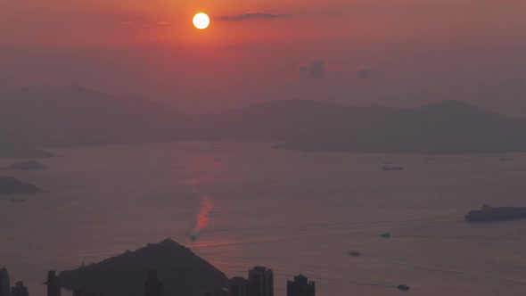 Timelapse Sun Sets Behind Hong Kong Harbor with Motorboats