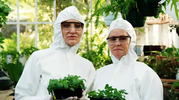 Female scientists holding pot plant