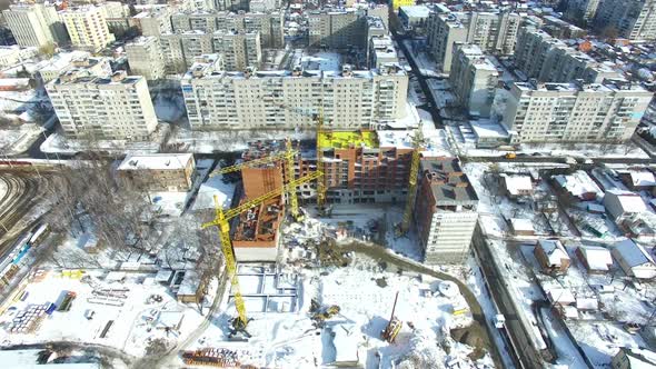 Construction site with cranes. Under construction high-rise building with construction cranes