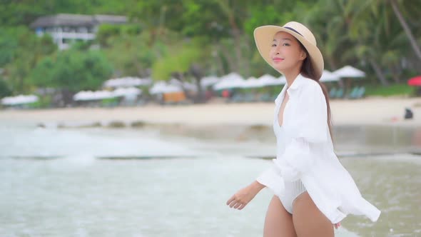 Asian woman enjoy around beautiful beach sea ocean