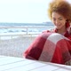 Beautiful Pensive Redhead Woman Sitting at the Beach Watching the Sea - VideoHive Item for Sale