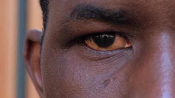 close up portrait on serious american african man's eye- macro