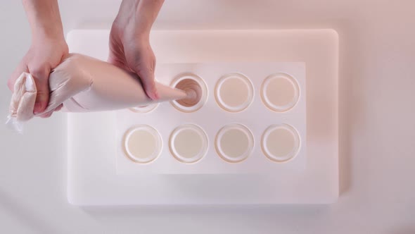 Pastry Chef Pours Mousse Cream Into a Silicone Cake Pan