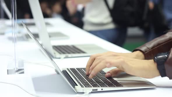 Girl Typing on a Modern Laptop