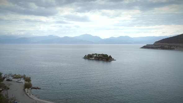 Aerial view of small island with a church near to the beach shore in Greece.