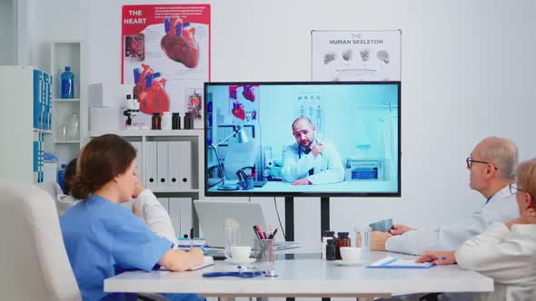 Medical People Holding Online Meeting in Boardroom with Man Specialist Doctor