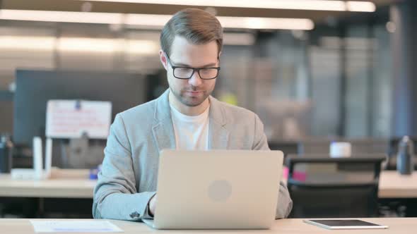 Man Working on Laptop in Office